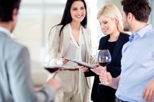 Group of young businesspeople toasting and celebrating in the restaurant